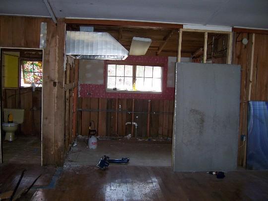 house06.JPG - Looking into the kitchen from the living room, a bathroom to the left.